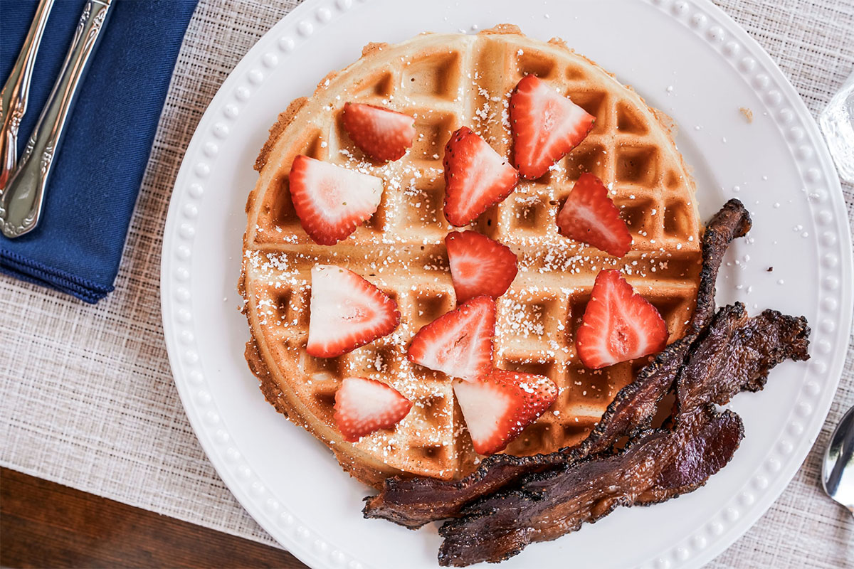 Waffle with strawberries and bacon